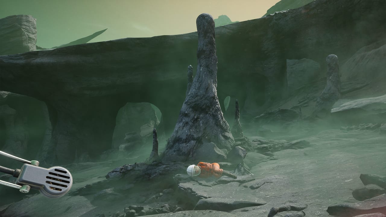 A screenshot from The Invincible showing a desolate desert world through the curved glass of a spacesuit helmet.