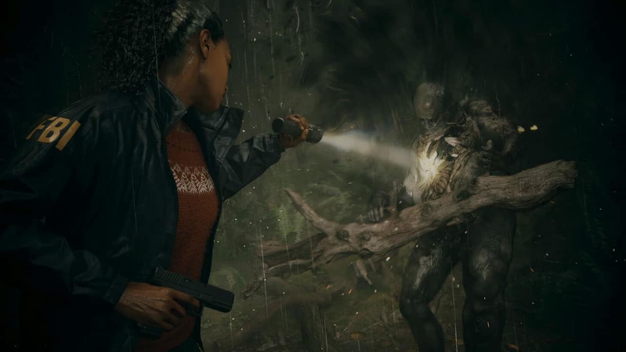 A screenshot from Alan Wake 2 of an FBI agent using a flashlight to confront a monster in the shadows.