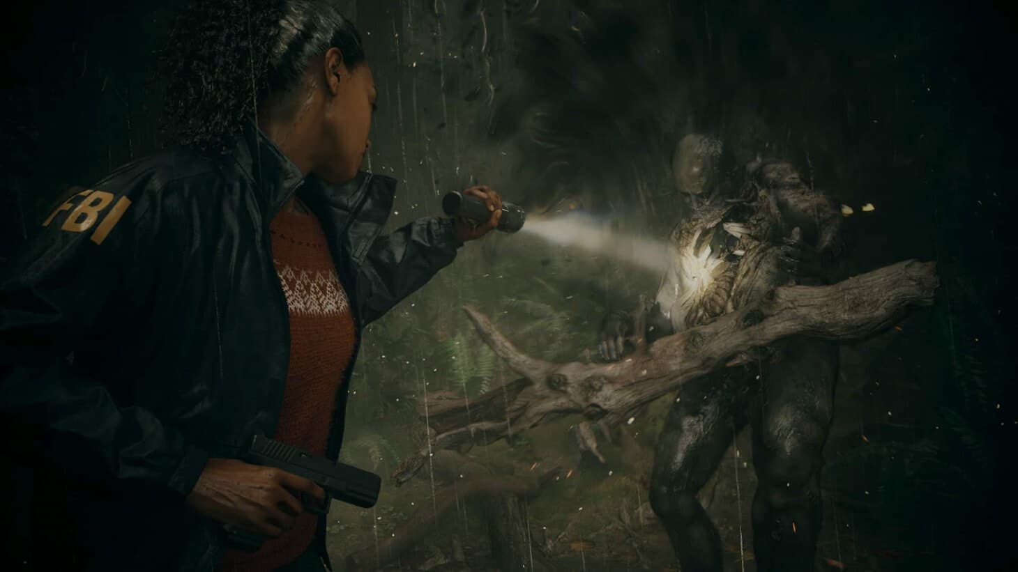 A screenshot from Alan Wake 2 of an FBI agent using a flashlight to confront a monster in the shadows.